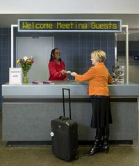 Welcome center attendee greets guest