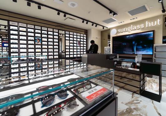 The interior of the Sunglass Hut store with display cases and a cash register